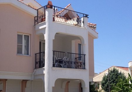 Apartment in Didim, Turkey: Exterior of apartment, showing lower level shaded balcony, and upper l..