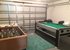 Games room in garage with pool table and table football.