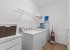 Utility room with washing machine, tumble dryer, ironing board