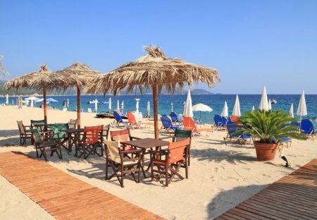 Villa in Peristerona, Cyprus: Beach bar with straw umbrellas and wooden deck on exotic resort