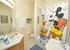 Mickey family bathroom has shower over bath and 2 separate vanity units