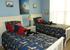 Slick Surfin'USA theme for  twin bed room has 31" flat screen smart TV