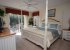 King-sized bed with TV and private balcony