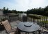 Balcony view of lake with table and chairs