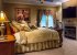 Master bedroom with Super King-size bed, fireplace, TV, & patio doors
