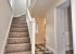 Main staircase from the reception room, leading to upstairs bedrooms