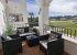 relax on the balcony overlooking the 18th green of the golf course.