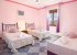 The pink room is also a common room but not just with single beds.