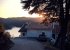 Witness a stunning summer sunrise from Blue Lake House tranquil road.