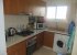 kitchen area showing washing machine ,microwave, oven , fridge freezer
