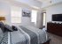 Primary king with en suite, TV, walk-in closet, ceiling fan