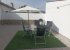Rear patio area with outdoor furniture and gas barbecue