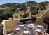 Terrace off living room, early morning sun, contains BBQ and canopy.