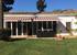 view of villa with awnings to shield from the sun in hot days